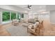 Spacious living room featuring light wood flooring, neutral walls, and a sliding glass door to the backyard at 213 Crest Ct, Weddington, NC 28104