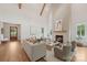 Comfortable living room boasts a cozy fireplace, plush seating, neutral decor, and hardwood floors throughout at 213 Crest Ct, Weddington, NC 28104