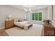 Bright bedroom features hardwood floors, a large window, and neutral decor at 213 Crest Ct, Weddington, NC 28104