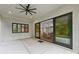 Covered outdoor patio with ceiling fan and sliding glass doors leading to the indoor living space at 213 Crest Ct, Weddington, NC 28104