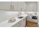 Elegant bathroom sink with bright fixtures, sleek countertops, white cabinets, and a modern design at 213 Crest Ct, Weddington, NC 28104