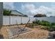 A serene backyard features raised garden beds, a white fence, and a patterned rug for outdoor relaxation at 2206 Whitworth Rd, Cherryville, NC 28021