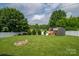 Expansive backyard featuring a fire pit, storage shed, and lush green grass with plenty of space at 2206 Whitworth Rd, Cherryville, NC 28021