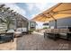 A charming outdoor patio with comfortable seating, shade, and patterned stone, ideal for relaxing or entertaining at 2206 Whitworth Rd, Cherryville, NC 28021