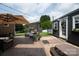 A backyard oasis featuring a patio, seating area, umbrella, landscaping, and an outbuilding with flower boxes at 2206 Whitworth Rd, Cherryville, NC 28021