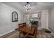 This charming dining room is perfect for gatherings, featuring stylish wallpaper and modern lighting with a brick fireplace at 2206 Whitworth Rd, Cherryville, NC 28021