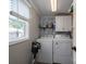 Bright laundry room features a window and updated appliances and storage that helps make everyday tasks a breeze at 2206 Whitworth Rd, Cherryville, NC 28021