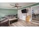 This cozy living room is perfect for relaxation with modern decor and laminate flooring for easy maintenance at 2206 Whitworth Rd, Cherryville, NC 28021