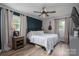 Relax in this main bedroom featuring a ceiling fan, lots of light and beautiful hardwood floors at 2206 Whitworth Rd, Cherryville, NC 28021