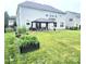 The backyard has a lush lawn, a patio area and a garden with raised beds at 2634 Treeline Dr, Concord, NC 28027