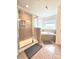 Bathroom with large shower, tiled walls and floors, and soaking tub near window at 2634 Treeline Dr, Concord, NC 28027