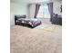 Bright carpeted bedroom featuring a large window, a bed, a dresser, and room for activities at 2634 Treeline Dr, Concord, NC 28027