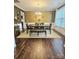 Formal dining room with modern chandelier, dark wood floors, and elegant furniture arrangement at 2634 Treeline Dr, Concord, NC 28027