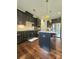 Modern kitchen features dark cabinets, granite countertops, stainless steel appliances and a central island at 2634 Treeline Dr, Concord, NC 28027