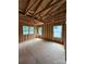 Under construction bedroom with wood stud walls, exposed beams and three new windows at 2735 Primrose Ave, Charlotte, NC 28208