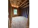 Under construction bedroom with wood frame and a bright window at 2735 Primrose Ave, Charlotte, NC 28208