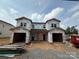 New construction duplex featuring two-car garages, Tyvek house wrap, and a modern design at 2735 Primrose Ave, Charlotte, NC 28208