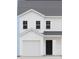 Newly constructed two-story home featuring white siding, black front door and a two car garage at 2735 Primrose Ave, Charlotte, NC 28208