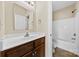 Bathroom featuring a wooden vanity, a toilet, a mirror, a shower and light fixtures at 2765 Clover Nw Rd, Concord, NC 28027