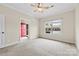 Carpeted bedroom with a window and red front door in view at 2765 Clover Nw Rd, Concord, NC 28027