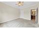 Bedroom with carpet, ceiling fan, and access to an en-suite bathroom at 2765 Clover Nw Rd, Concord, NC 28027
