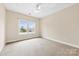 Spacious bedroom with carpet, ceiling fan and large window with natural light at 2765 Clover Nw Rd, Concord, NC 28027