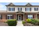 Charming townhouse featuring brick facade, symmetrical windows, and manicured landscaping at 2765 Clover Nw Rd, Concord, NC 28027