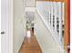 Hallway with hardwood floors, stairs, and a view into the living room at 2765 Clover Nw Rd, Concord, NC 28027