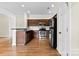 A kitchen with stainless steel appliances, tile backsplash and wooden cabinets at 2765 Clover Nw Rd, Concord, NC 28027