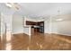 Open-concept living area with hardwood floors, dark wood kitchen, and a ceiling fan at 2765 Clover Nw Rd, Concord, NC 28027