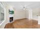 Open living room with hardwood floors, fireplace, ceiling fan and large windows at 2765 Clover Nw Rd, Concord, NC 28027