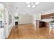 Bright living room with a fireplace, hardwood floors, and an adjacent eat-in kitchen at 2765 Clover Nw Rd, Concord, NC 28027