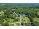 An aerial view of a house with a large, tree-lined lot, approximated in blue, in a quiet, residential neighborhood at 3269 Tolley St, Claremont, NC 28610