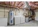Basement featuring a washer, dryer, and water heater with exposed ducts and insulation at 3269 Tolley St, Claremont, NC 28610