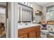 Well-lit bathroom with wooden vanity, large mirror, and neutral decor at 3269 Tolley St, Claremont, NC 28610