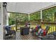 Covered deck with comfortable seating, wood railings, and view of the backyard at 3269 Tolley St, Claremont, NC 28610