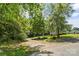 Driveway to the home leading through beautiful trees to a well-maintained front yard and home at 3269 Tolley St, Claremont, NC 28610