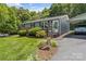 Well-kept home featuring charming landscaping, a cozy front porch and a covered carport at 3269 Tolley St, Claremont, NC 28610
