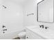 Bright bathroom featuring white cabinetry, a white countertop, and a shower tub combo with black hardware at 332 Hollingswood Dr, Statesville, NC 28625