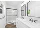 Bathroom featuring double vanity sinks with black hardware and a glass enclosed shower with marbled tile at 332 Hollingswood Dr, Statesville, NC 28625