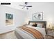 Staged bedroom with a large window, a ceiling fan, a queen bed and a green tree next to the window at 332 Hollingswood Dr, Statesville, NC 28625