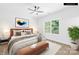 Staged bedroom featuring a large window, a ceiling fan, a queen bed and a bench at the foot of the bed at 332 Hollingswood Dr, Statesville, NC 28625