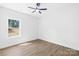 Bedroom featuring a large window, a ceiling fan, and light wood flooring at 332 Hollingswood Dr, Statesville, NC 28625