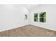 Bright bedroom features durable wood-look flooring, sunny window, and a door to the outside at 332 Hollingswood Dr, Statesville, NC 28625