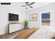 Staged bedroom featuring a ceiling fan, a dresser with a TV, and a window overlooking the backyard at 332 Hollingswood Dr, Statesville, NC 28625