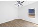 Bright bedroom features modern ceiling fan, and durable wood-look flooring plus a sunny window at 332 Hollingswood Dr, Statesville, NC 28625