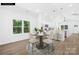 Bright dining area with hardwood floors and stylish modern furniture at 332 Hollingswood Dr, Statesville, NC 28625