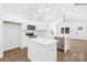 Modern kitchen with white cabinets, stainless steel appliances, and a large island at 332 Hollingswood Dr, Statesville, NC 28625