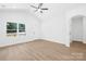 Bright, empty living room features high ceilings, wood-look flooring, and large windows at 332 Hollingswood Dr, Statesville, NC 28625