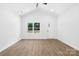 Bright, empty living room features high ceilings, wood-look flooring, and large windows at 332 Hollingswood Dr, Statesville, NC 28625
